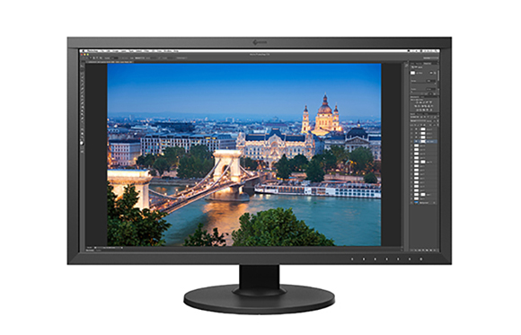 A black computer monitor displaying a photo of a city skyline and bridge over water in a photo editing program.