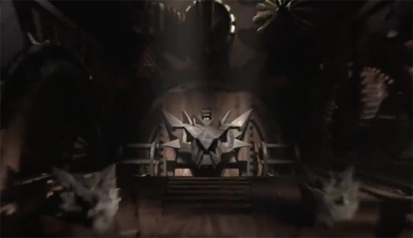 A large, sharp-edged metallic object sits centered in a dark, dimly lit cavernous room.