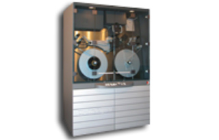 A tall, grey industrial machine with a glass display showing internal mechanical components and two large circular reels.
