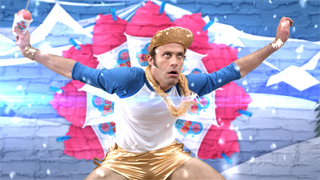 A man in a gold beret and white shirt dances with arms outstretched against a pink cupcake background.