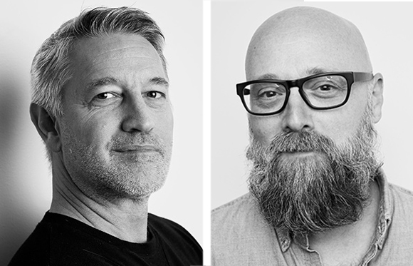 Two black and white headshots of men; one with short hair and one bald with a full beard and glasses.