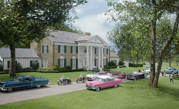 Classic cars and motorcycles parked on a driveway before a large white-columned stone estate.