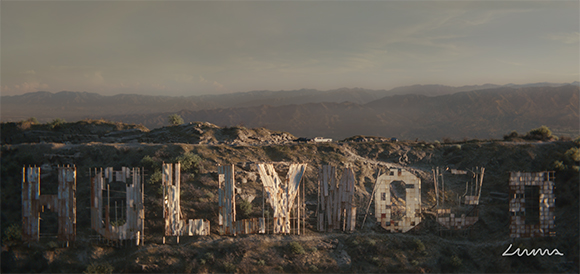 Large, weathered wooden letters spelling HOLLYWOOD on a dry, hilly landscape under a dim sky.