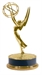 A gold Emmy Award trophy featuring a winged woman holding an atom symbol on a dark circular base.