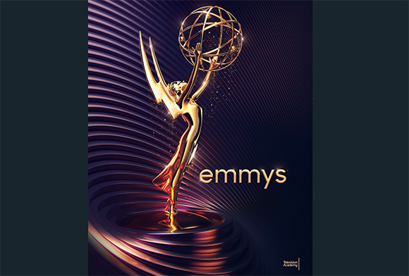 A golden Emmy Award trophy stands against a dark purple background with swirling light patterns.