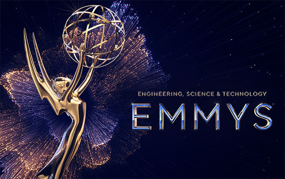 Golden Emmy Award trophy against a dark blue background with light streaks and text reading 'ENGINEERING, SCIENCE & TECHNOLOG