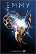 A golden Emmy Award trophy emitting bright white light and sparkles against a dark blue backdrop.
