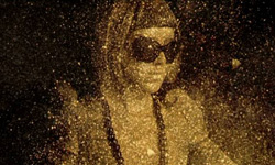 A person's silhouette dissolving into a cloud of shimmering golden particles against a dark background.