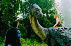 A person stands near a large, long-necked dragon in a dense, green forest.