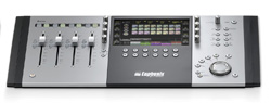A silver and black digital audio mixing console with four faders and a central screen.
