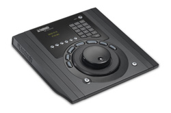 A black electronic control device featuring a central joystick, a numeric keypad, and a small digital display.