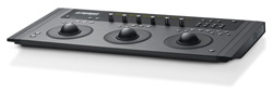 A black electronic control panel featuring three large trackballs and various knobs and buttons.