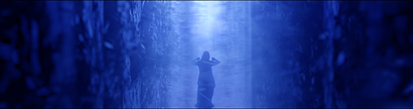 Silhouette of a person standing in a glowing, blue-lit cavernous environment.