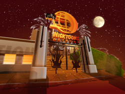 Entrance to Nicktoons Studios at night with a large orange logo and a full moon in a starry sky.