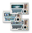 Three silver electronic control consoles with various buttons, screens, and dials.