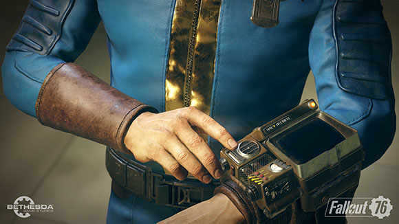 A person in a blue jumpsuit uses their finger to interact with a bulky, metallic wrist-mounted device.