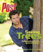 Man peeking from behind a tree on a magazine cover about saving trees and Hollywood's green initiatives.