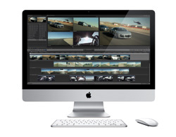 An iMac computer showing a video editing interface with multiple video clips and timelines on the screen.