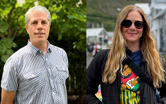 A man in a blue checkered shirt stands next to a woman with long blonde hair wearing sunglasses.