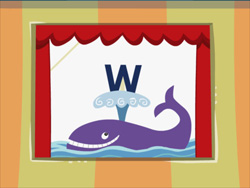 A purple cartoon whale swimming in blue waves below a large blue letter W, framed by red stage curtains.