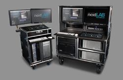 Two black mobile workstations with multiple monitors and server equipment on wheels.