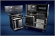 Two mobile medical workstations on wheels with multiple digital displays and electronic components.