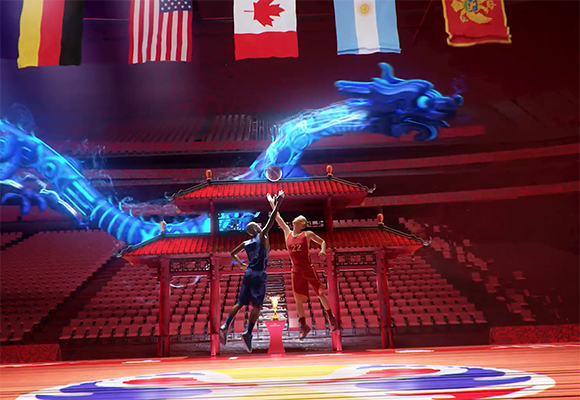 Two basketball players jump for a ball in a red arena with a large blue dragon and international flags above.