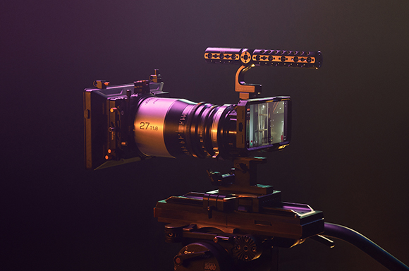 A professional cinema camera with a large lens and matte box mounted on a tripod under colored lighting.