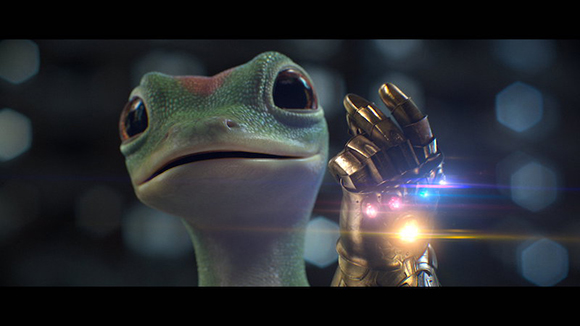 A green gecko looking at a metallic gauntlet with glowing colorful lights.