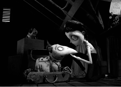 Black and white stop-motion scene of a pale character looking at a small creature inside an open suitcase.