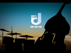 Silhouettes of a double bass, drum kit, and cymbals against a sunset sky with a BET logo.
