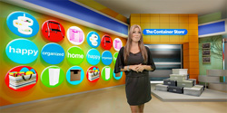 A woman in a black dress stands before a wall of colorful circular icons and storage bins.