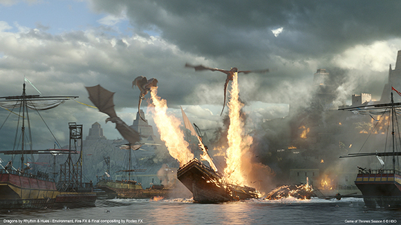 A dragon breathes a stream of fire onto a wooden ship in a harbor near a large stone city.