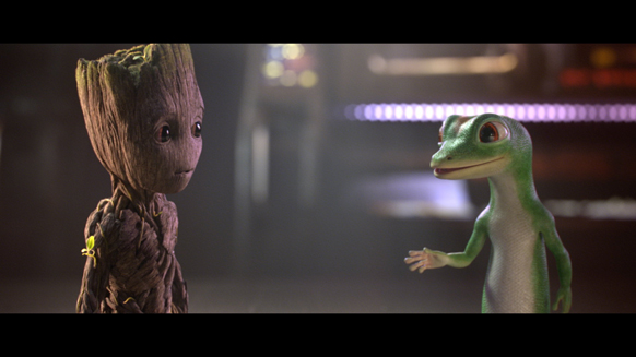 A small wooden creature and a green lizard-like creature face each other in a dimly lit setting.