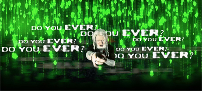 A man with long white hair and tattoos sits before a green digital rain background with repeating text.