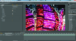 A video editing software interface showing a timeline and a vibrant, multicolored abstract video clip.