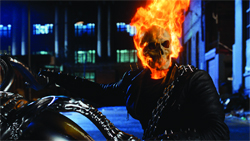 A person with a skull for a head engulfed in orange flames, wearing a black leather jacket.