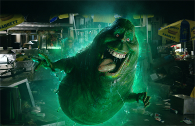 A large, glowing green spectral creature with a wide mouth and sharp teeth in a dark setting.