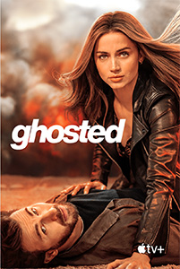 A woman in a black leather jacket sits over a man lying on the ground against a fiery background.
