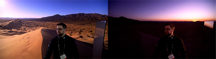 A man in glasses stands in a desert landscape under a twilight sky.