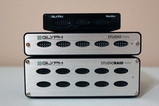 Three silver and black Glyph audio interfaces stacked on top of each other.