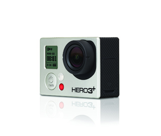 A silver and black GoPro HERO3+ action camera centered on a white reflective surface.