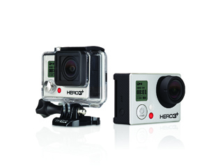 Two small action cameras, one in a clear waterproof case and one in a silver housing, on a white surface.