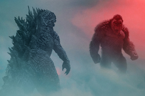 A giant reptilian monster and a massive gorilla stand facing each other through thick fog.