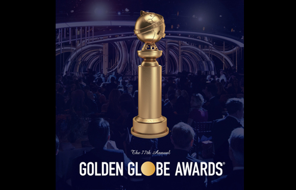 A gold Golden Globe trophy stands in front of a dark, blurred audience at an awards ceremony.