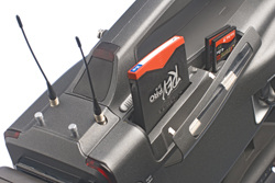 A dark grey electronic device with two thin antennas and two memory cards slotted into the top.