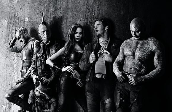 Five characters from Guardians of the Galaxy pose together in a black and white studio portrait.