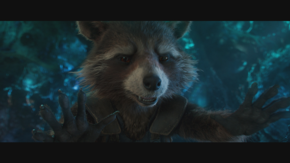A furry, raccoon-like creature reaches its paws toward the camera against a blue, glowing background.