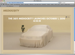 A website displaying a car under a beige cover with text reading 'THE 2011 MEDIOCRITY LAUNCHES OCTOBER 1, 2010'.