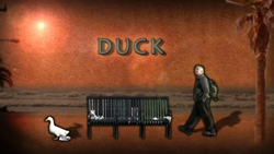 A man walks past a bench and a white bird in a desert landscape under the word DUCK.